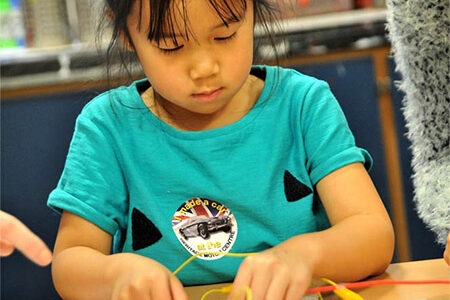 young girl doing squishy circuits