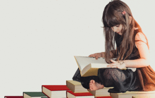 young girl sitting crosslegged on a pile of books, reading another book