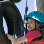 girl high on a vertical ropes course