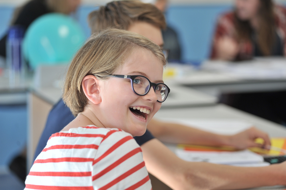 Girl laughing during the Enigma Challenge at Potential Plus UK's Big Family Weekend, 2018