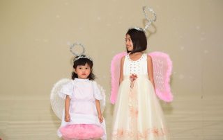 two girls dressed as angels for a nativity play