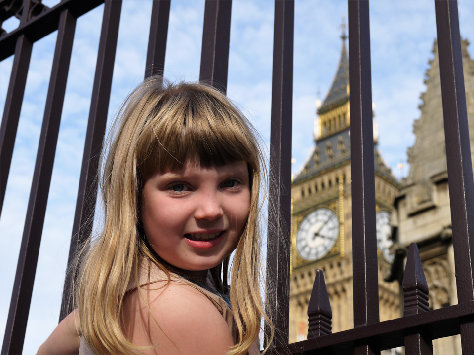 Girl outside the railings near Elizabeth Tower