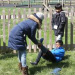 The water is meant to stay outside of the wellies! mother helps her son take off his wellington boots after a splash in the stream at the PPUK Be Curious Weekend 2019