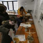 Children and parents weighing cooking ingredients with old fashioned weighing scalesat the PPUK Be Curious Weekend 2019