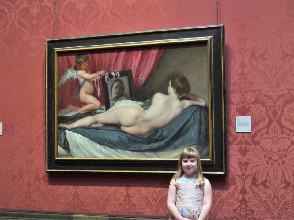 Girl standing under the Rokeby Venus in the National Gallery