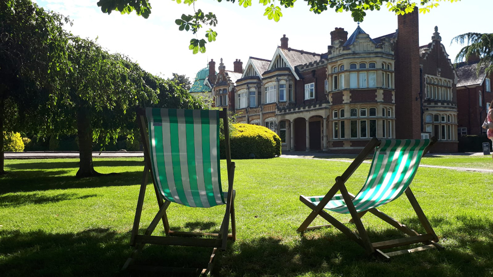 2 deckchairs in the sunshine in front of The Mansion, Bletchley Park