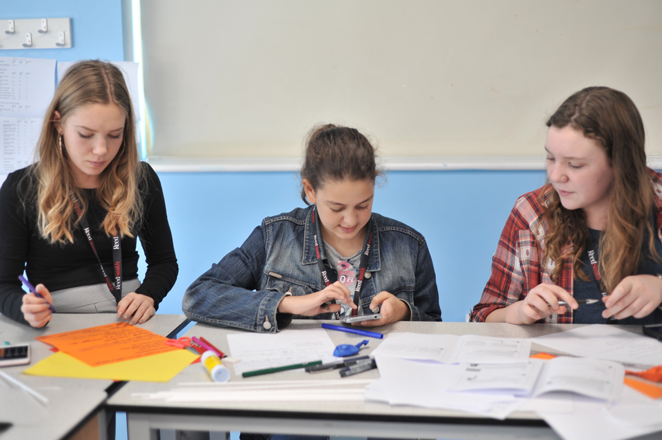 3 girls working at a table at the Big Family Weekend, 2018