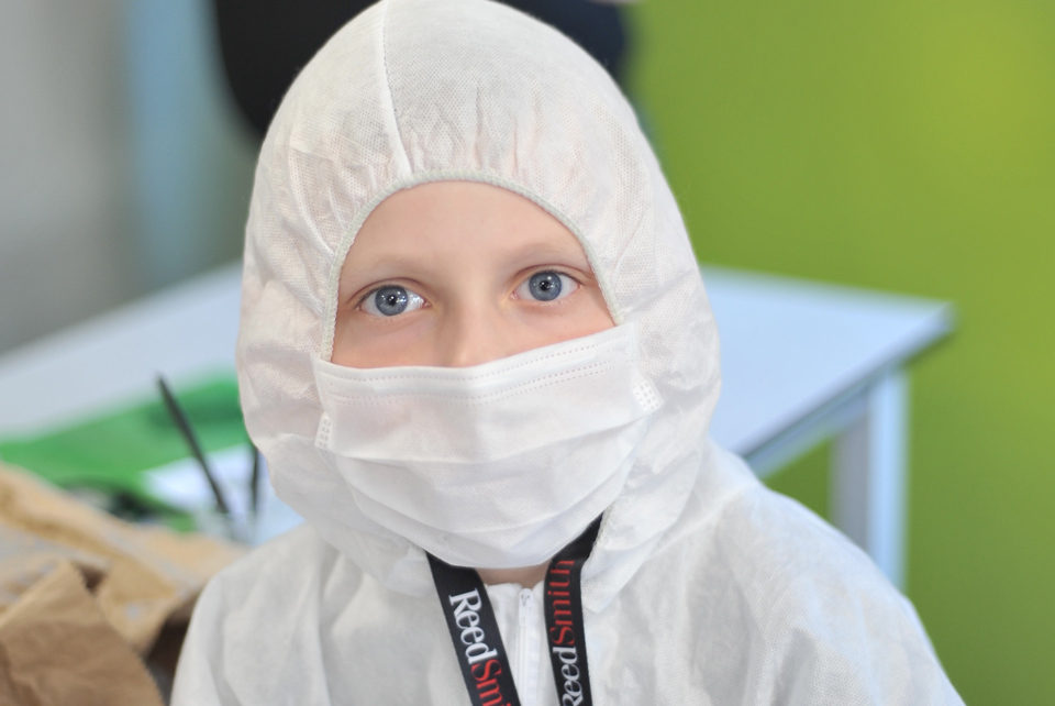 child in a surgical mask and CSI Forensic boilersuit from Big Family Weekend 2018