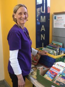 Volunteer Hilary Ramsden running the book stall at Potential Plus UK's BIG Family Weekend, 2019