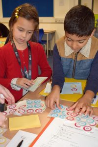 Two children collecting Skills Builder stickers at Potential Plus UK's Big Family Weekend, 2019