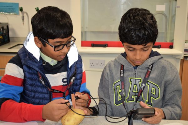 Two boys measuring power created by a potato Potential Plus UK's BIG Family Weekend, 2019