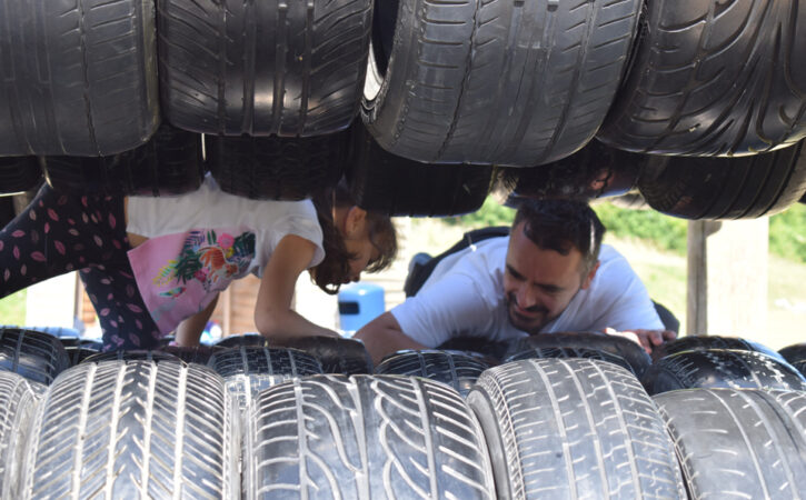 child and father on an obstacle course