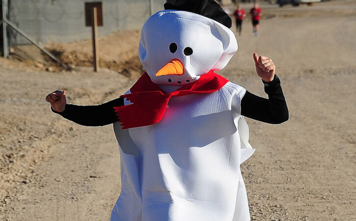 Person running in a race in a snowman costume