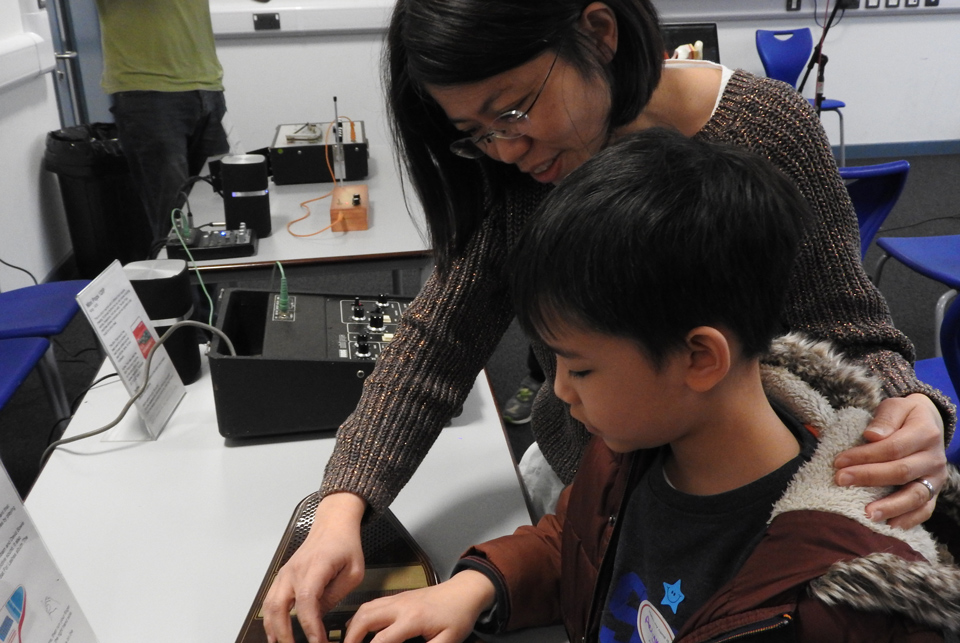 Mother helping child with technology