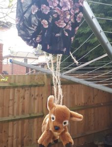 Fawn toy hanging from a parachute