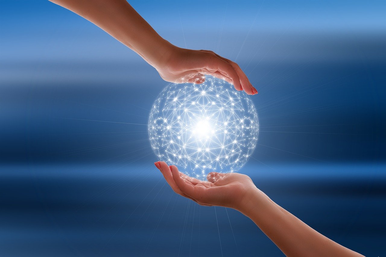 Two hands cupping a ball of light