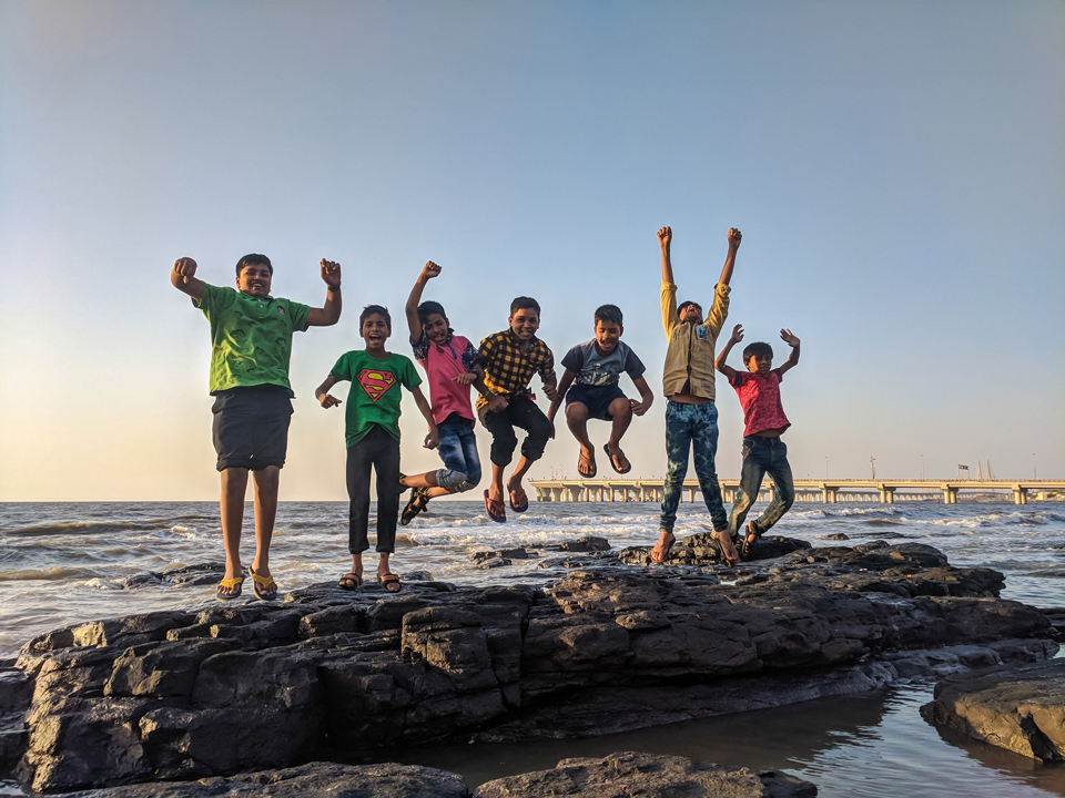 Group of Children on the seashore jumping for joy