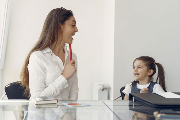 Woman and young child at a table laughing