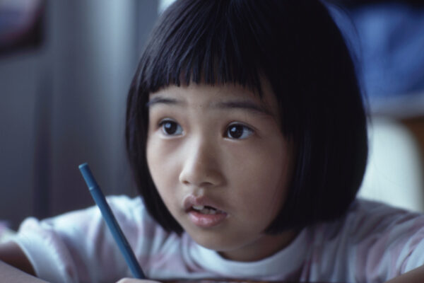 Young child holding a pen