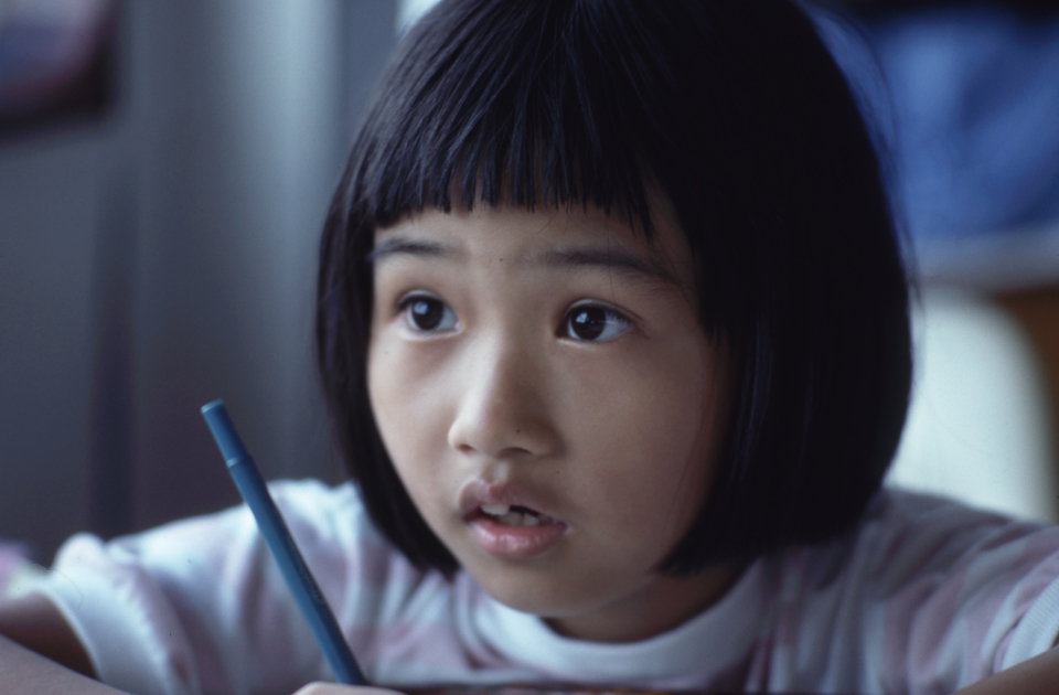 Young child holding a pen