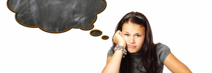 Girl sitting in front of a textbook, with an empty thought cloud from her head