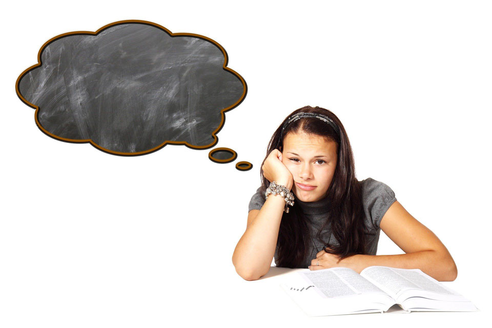 Girl sitting in front of a textbook, with an empty thought cloud from her head