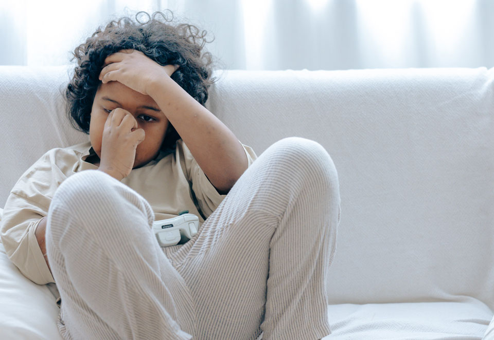 Boy sitting upset on the sofa