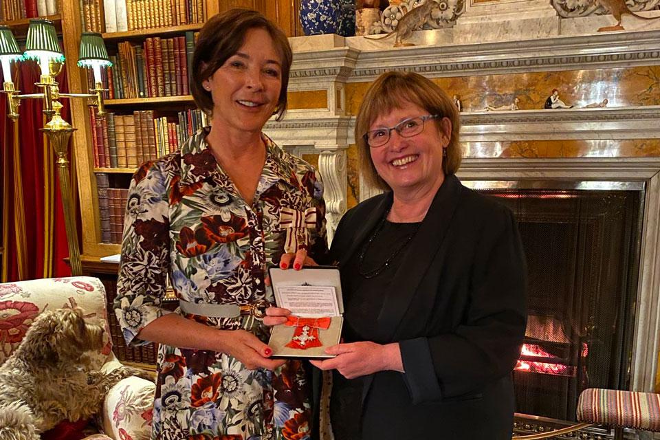 Denise Yates (right) being presented with her MBE at Alnwick Castle, March 2022