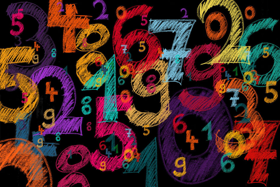 number digits in coloured chalk on a black background