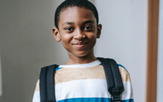 Smiling young lad wearing a rucksack