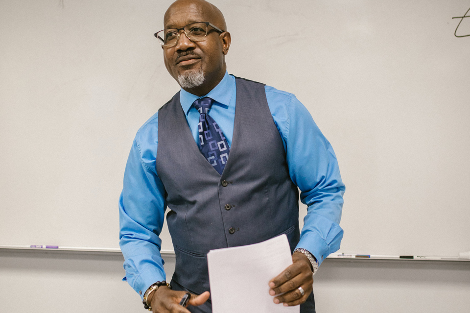 Male teacher standing in front of a whiteboard