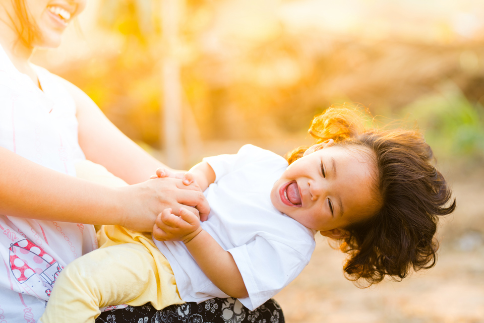 young child being spun around by her mother