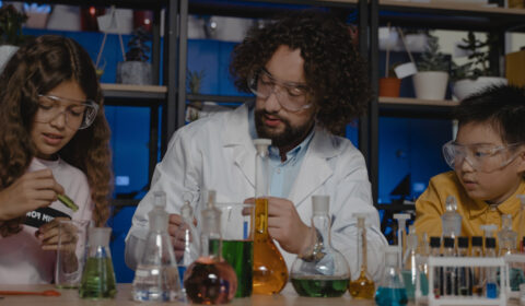 Science demonstration with man working with two young people