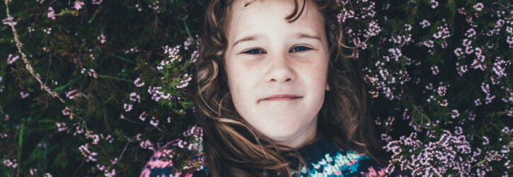 Girl lying in a field of heather