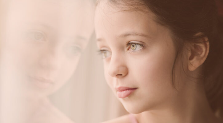 Girl staring with reflection in window