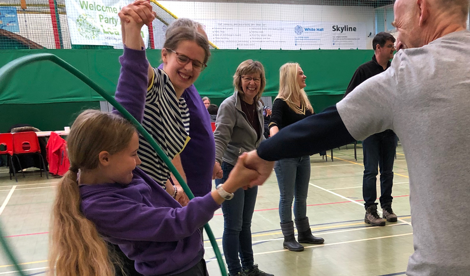 trying to get through a hoop while holding hands team games at Lea Green Centre, Let's Explore Day, October 2021