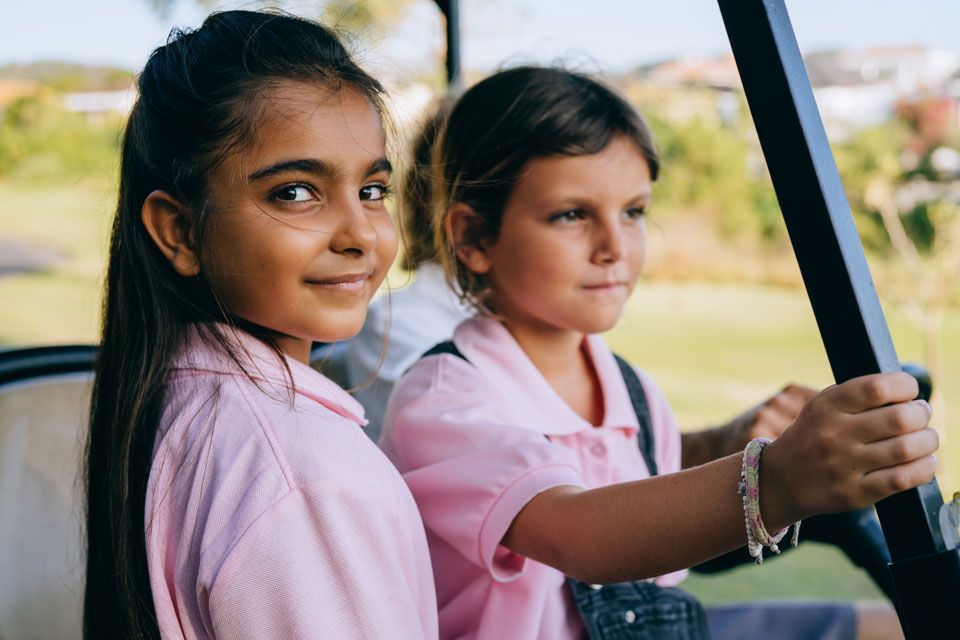 two girls on an outdoor visit in a jeep