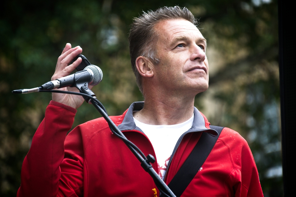 Chris Packham standing at a rally by a microphone