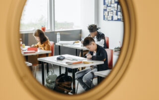 looking through a door into a classroom with students