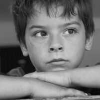 boy staring out of a window