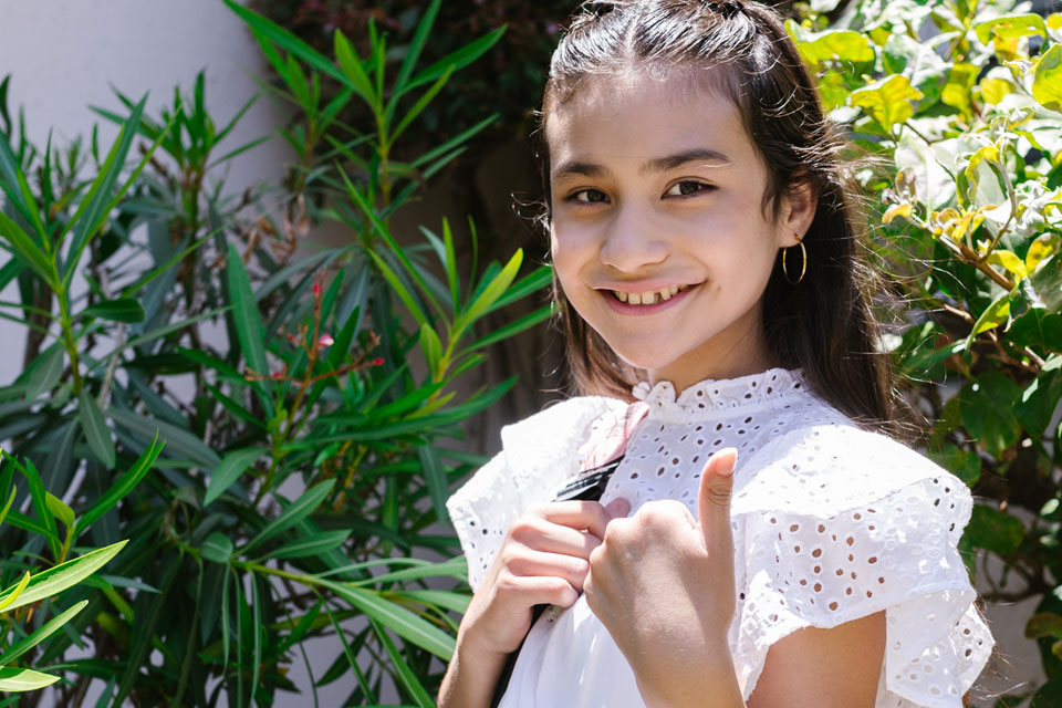 young girl with thumbs up