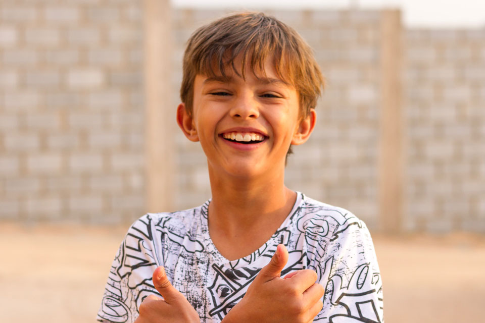 smiling boy with thumbs up