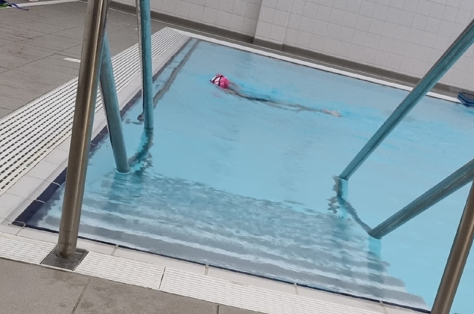 young girl swimming in swimming pool