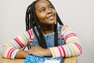 pexels-rodnae-productions-6936009_960 girl at desk looking up, happy