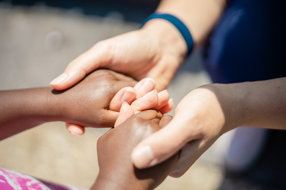 two people holding hands in support