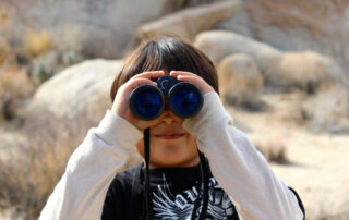 Child looking through binoculars