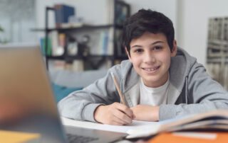 teenage boy working at his laptop
