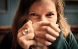 Happy woman drinking a cup of tea