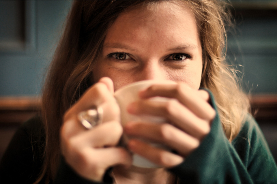 Happy woman drinking a cup of tea