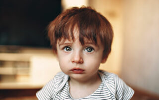 toddler boy looking sad